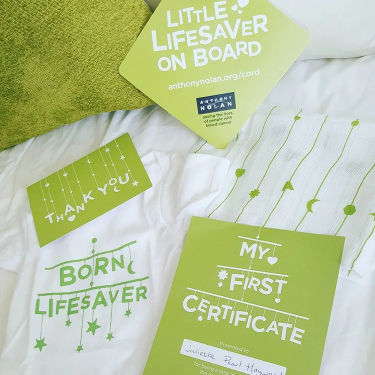 Car sign, thank you postcard, certificate and babygrow laid out together