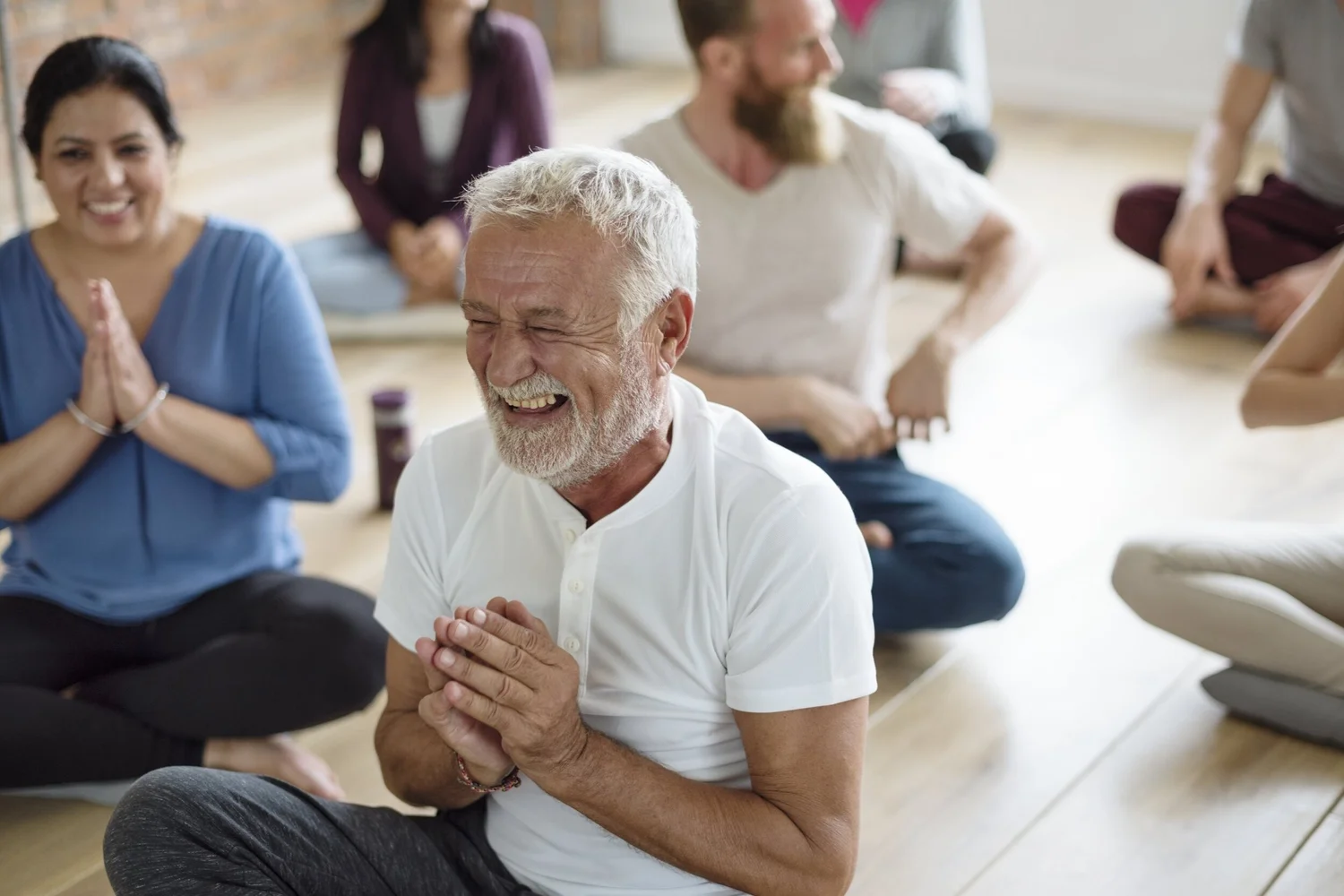 Older adults laughing together during a group exercise class