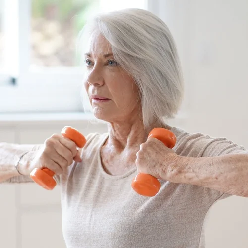 Persona photo for Amanda, a patient maintaining rehab: an older woman exercising with hand weights