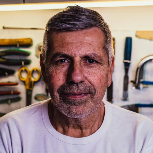 Persona photo for John, a patient starting rehab: a man in his sixties in a workshop